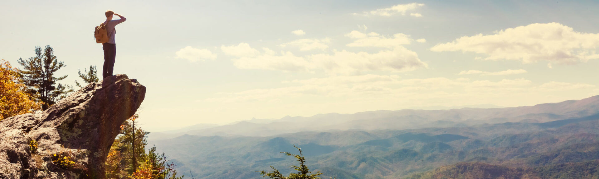 Man Overlooking The Mountains Below